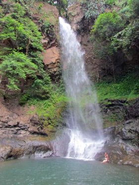 El Valle de Anton, Panama waterfall, with woman near the base – Best Places In The World To Retire – International Living